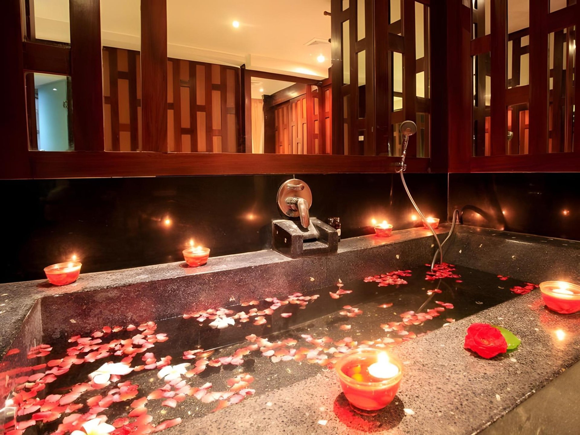 Romantic candlelit tub with rose petals