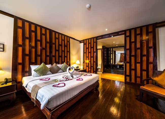 Deluxe Pool View — interior with teak floors