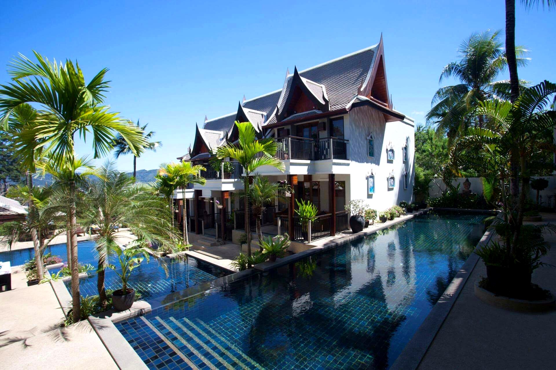 Pool and Thai buildings under blue sky