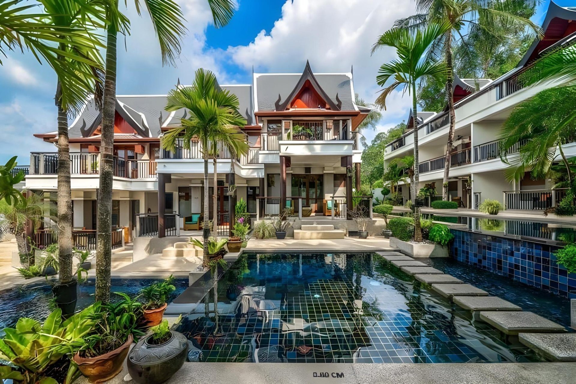 Courtyard pool reflecting the Thai gables