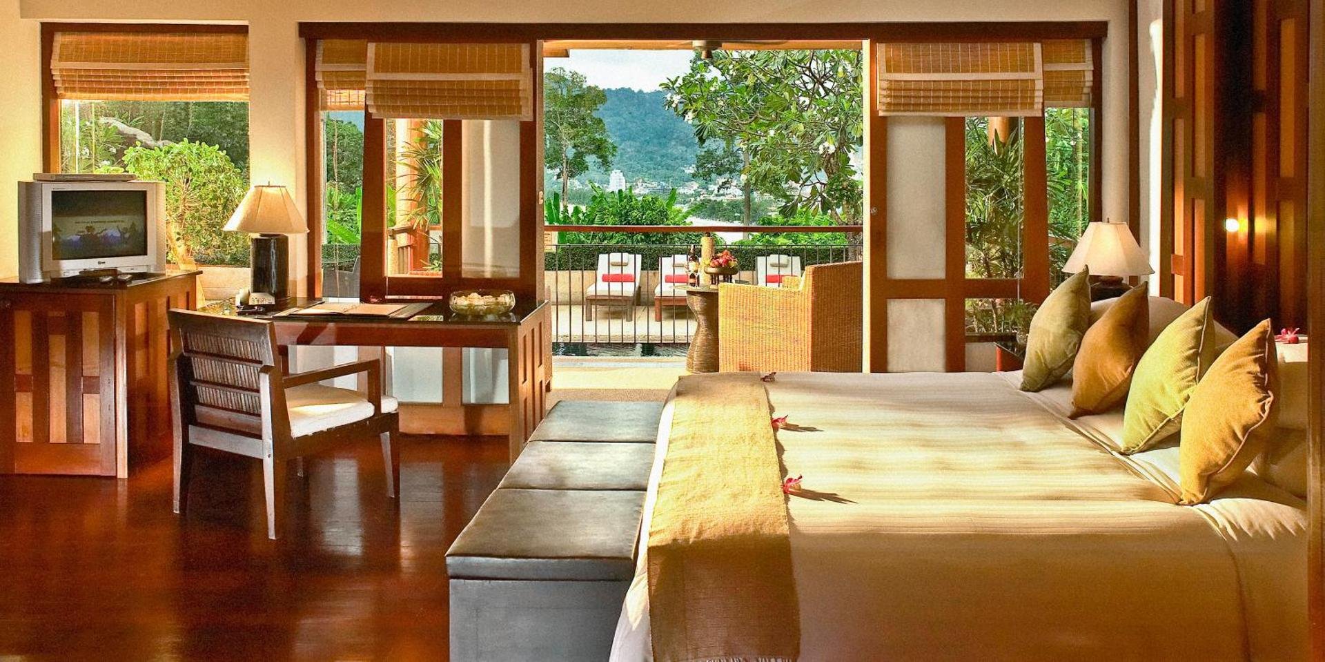 Warm king with balcony doors open to the bay