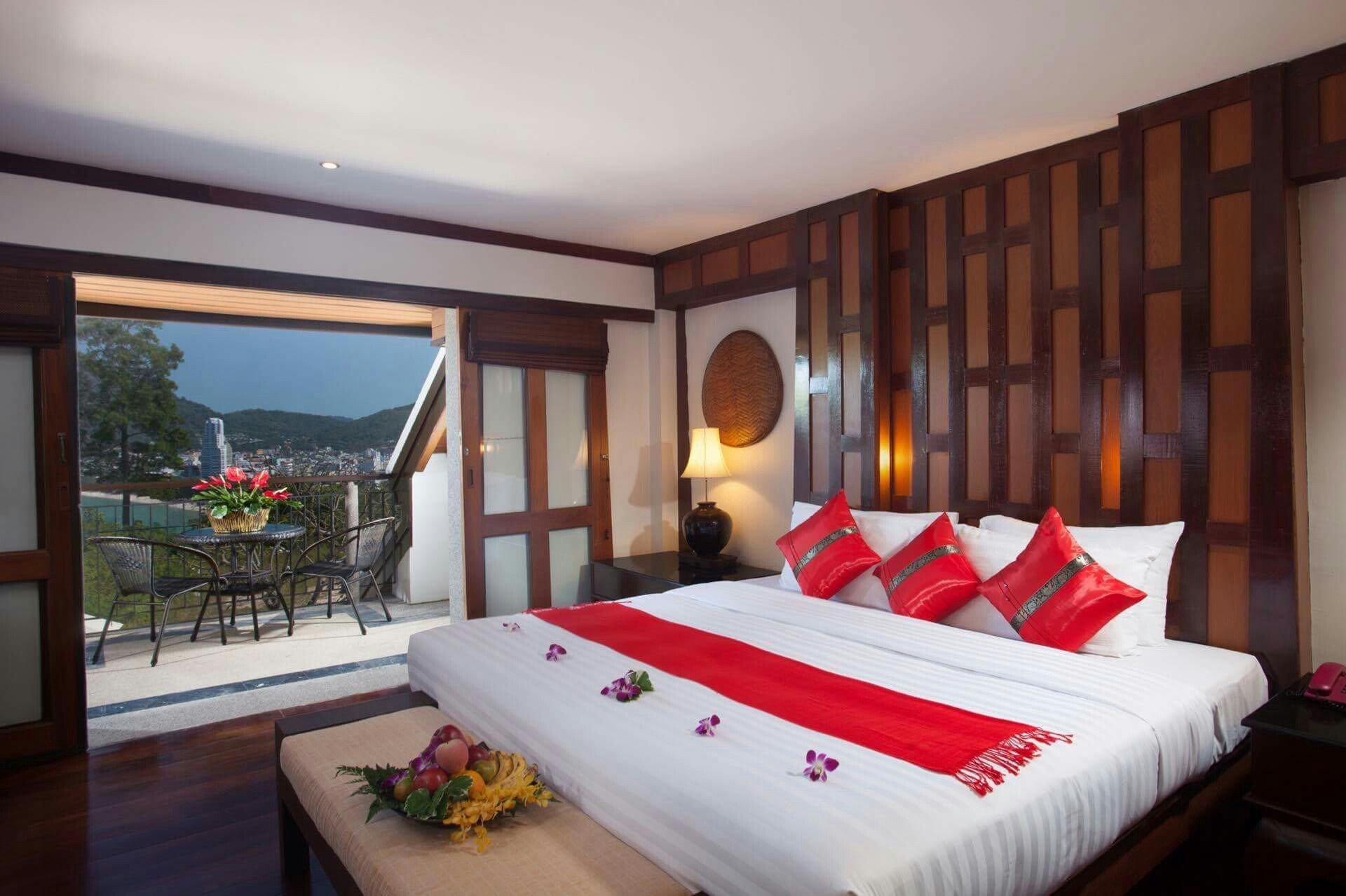 Romantic king with red pillows + balcony bay view