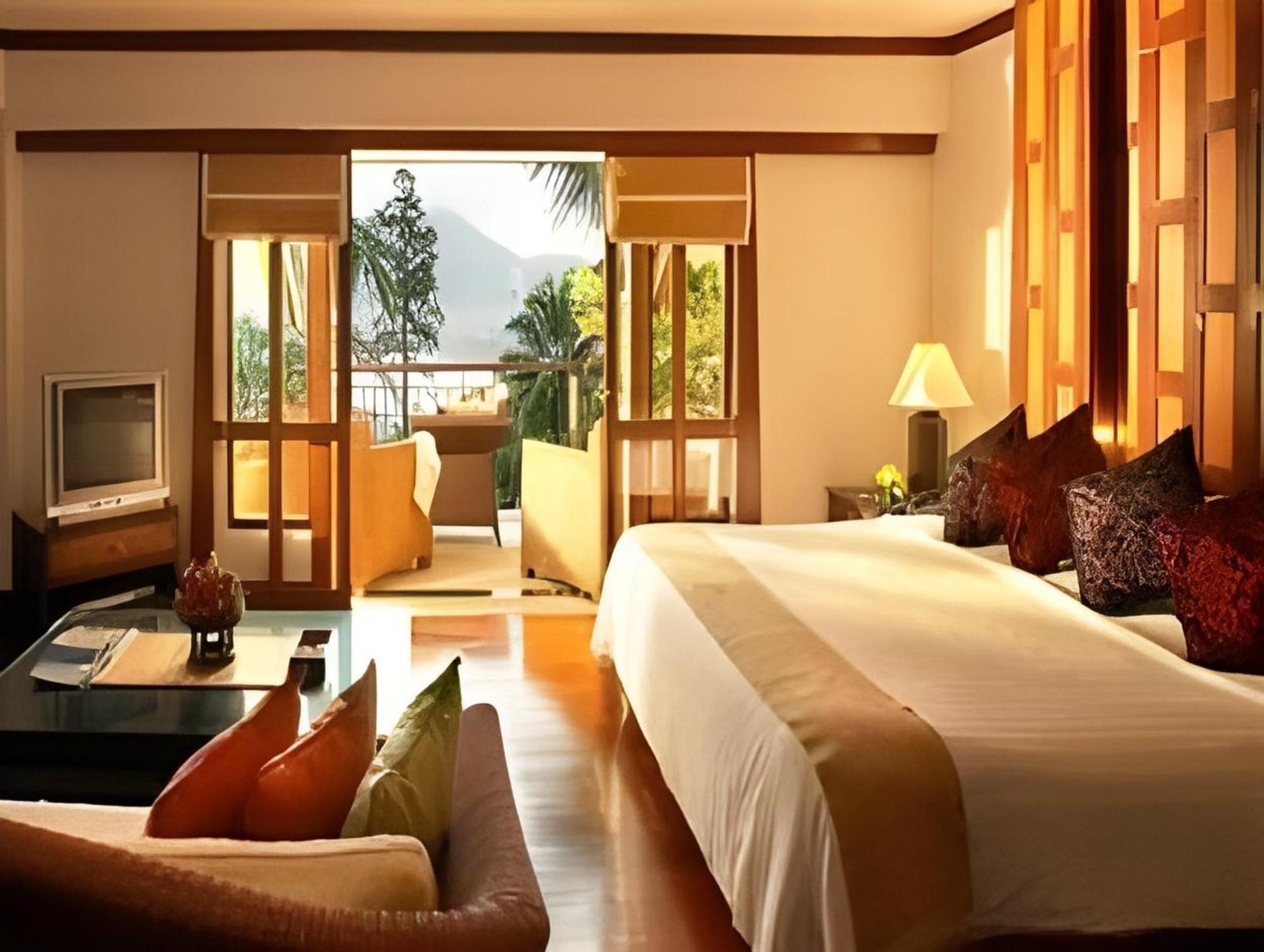 Pitched teak-ceiling king with balcony doors open to the bay
