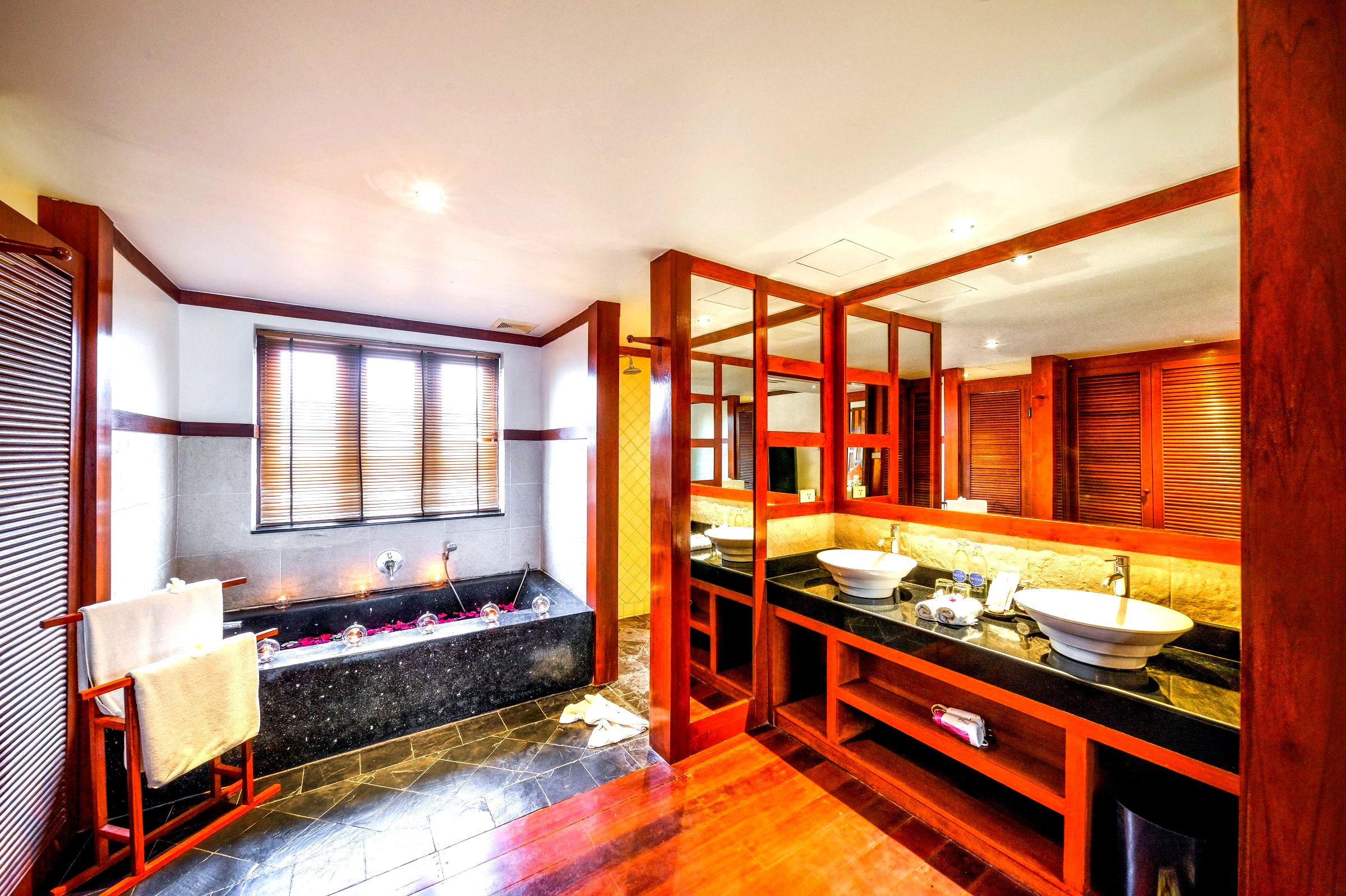 Teak bathroom with slate tub