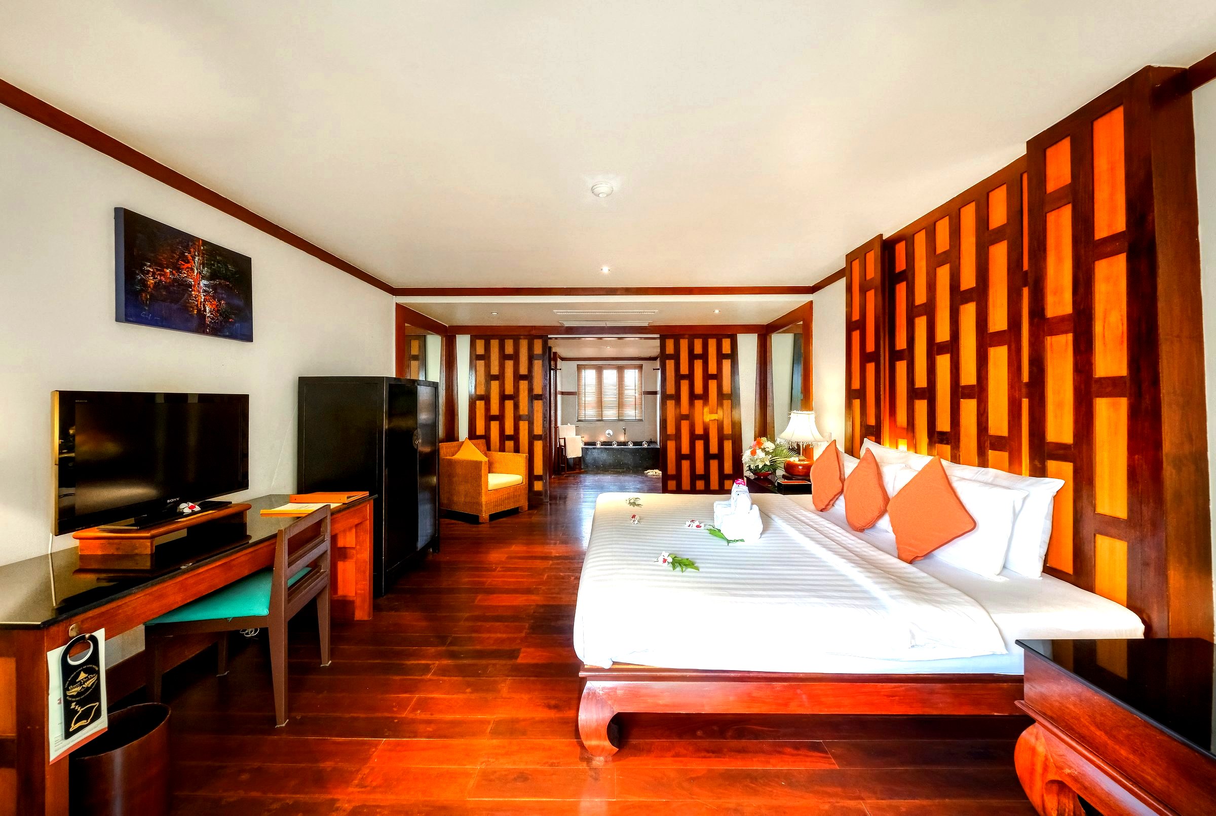 Deluxe Pool View room with carved wood lattice and king bed
